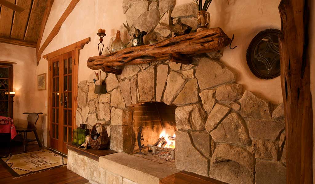 12 Cozy & Beautiful Fireplaces http://www.beautifuldesignmadesimple.com large rustic stone fireplace complemented by natural wood floors Photo: I Love Cob